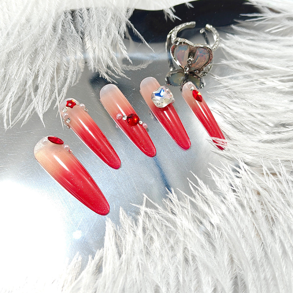 Artificial nails in elegant ombre style with glitter and jewelry accents Kalsten