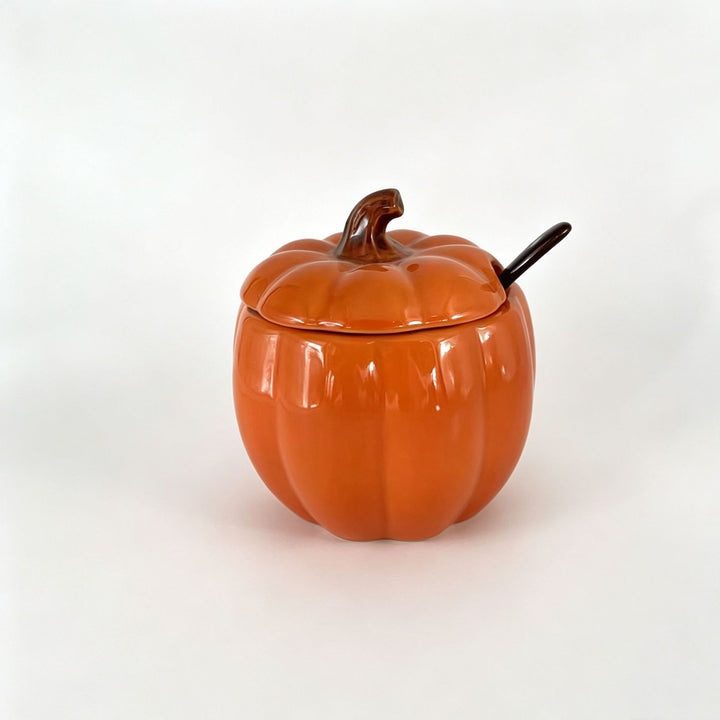 Ceramic storage jar in pumpkin shape with lid and spoon
