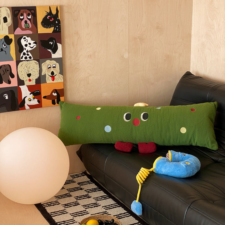 Extra-long plush sofa cushion with appliqués and plush feet