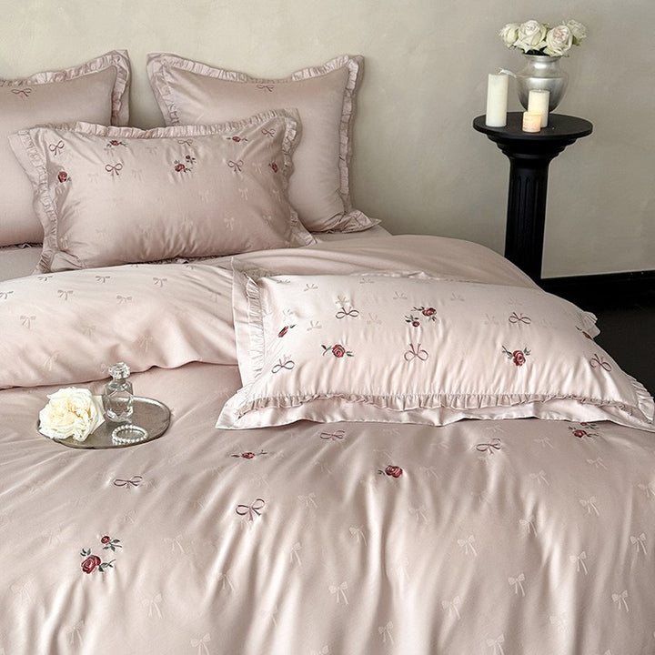 Luxurious satin bedding set with delicate floral embroidery and ruffles