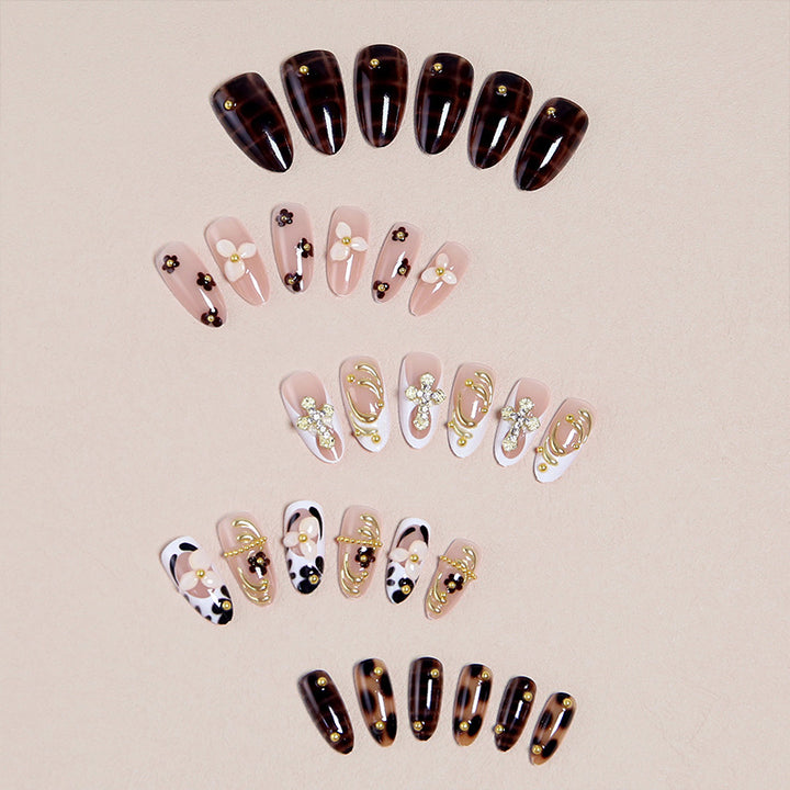 Artificial nails set with elegant gold accents and floral embellishments Kalsten