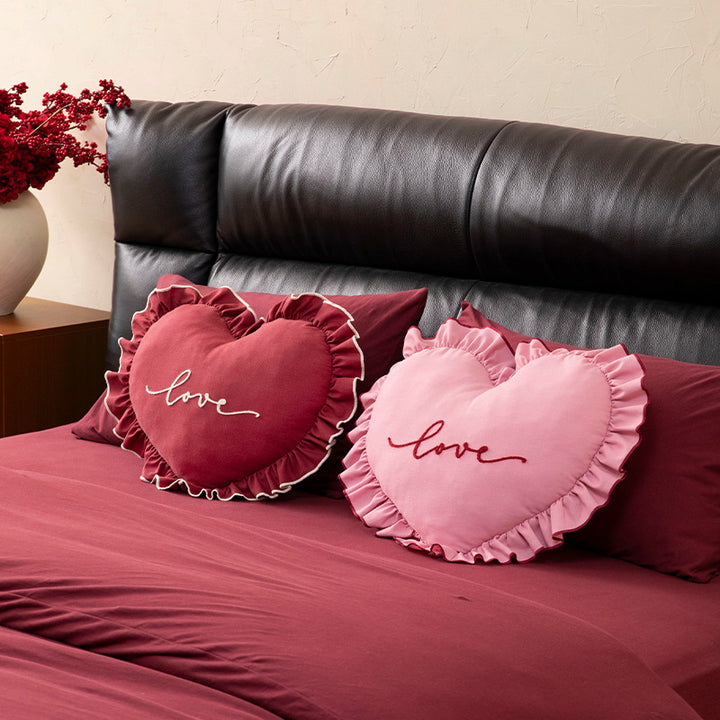 Heart-shaped decorative cushion with ruffles and embroidered text Kalsten