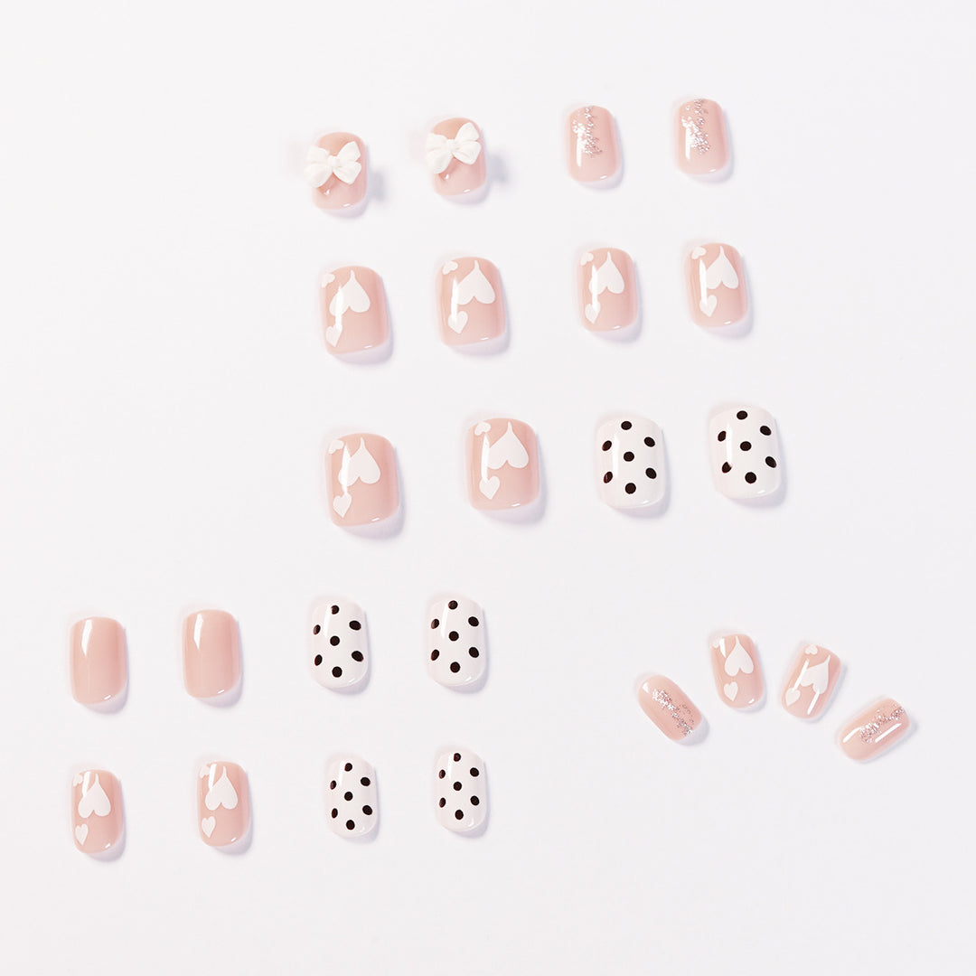 Artful nail art with delicate flower and heart motifs Kalsten