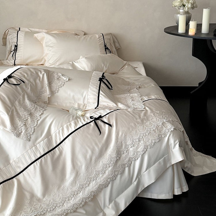 Fine cotton satin bedding set with lace ruffle, contrasting decorative ribbons and hotel closure