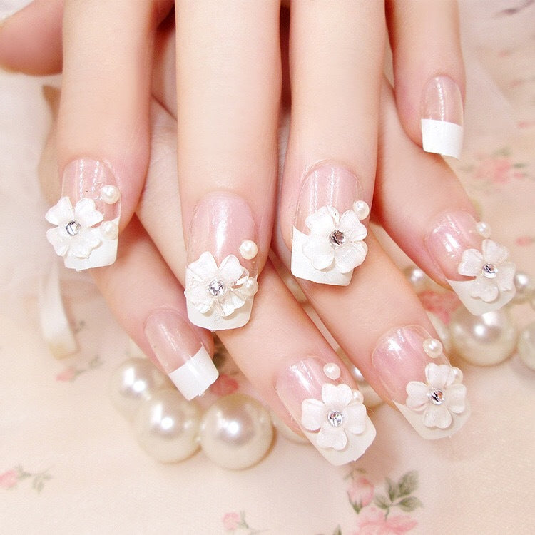 Artificials nails with sparkling rhinestone accents and elegant flower embellishments Kalsten
