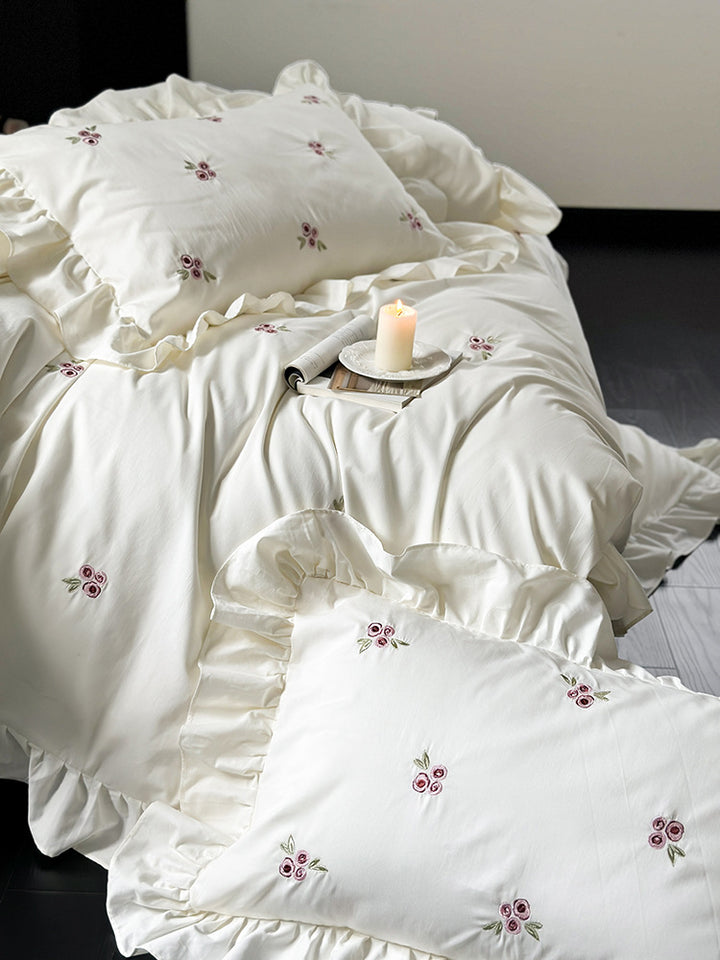 Elegant bed linen set made of breathable cotton satin with delicate floral embroidery and ruffled hem