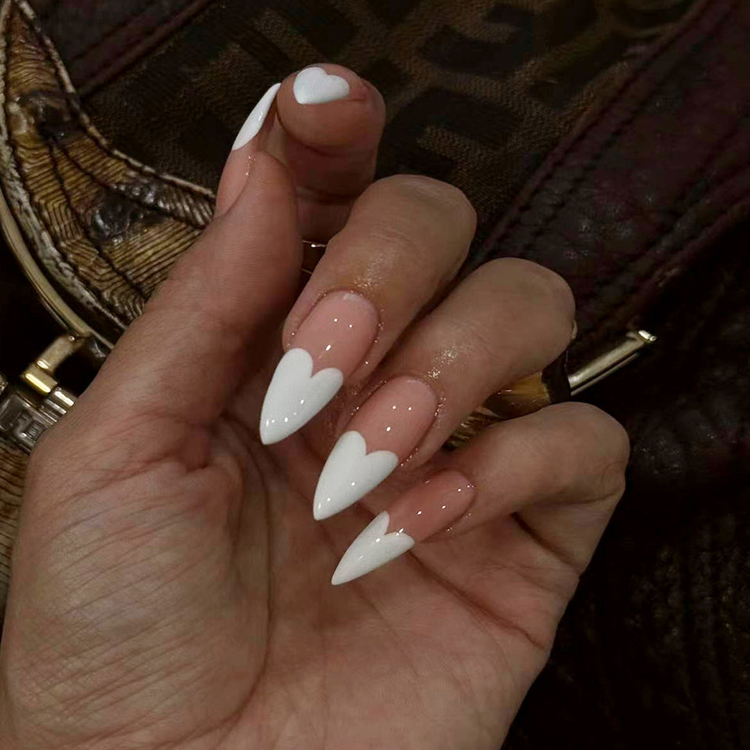 Elegant stiletto artificial nails with heart accents Kalsten
