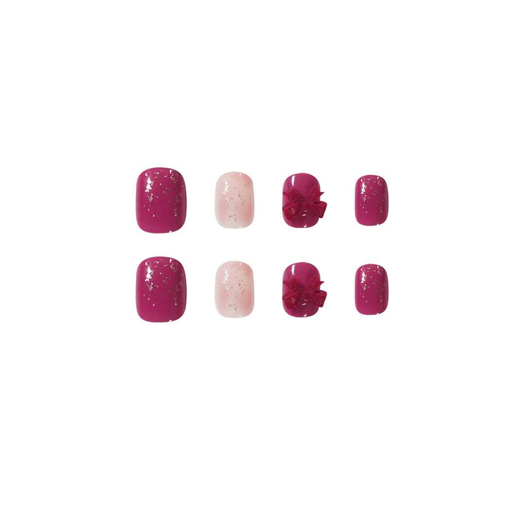 Artificial nail art with glitter embellishments and cute bow motif Kalsten