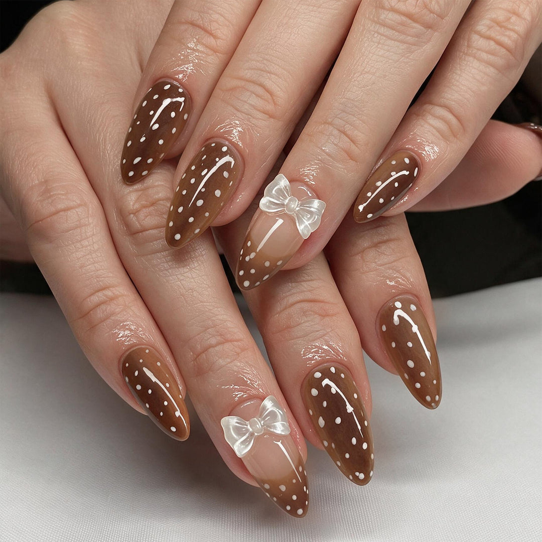 Artistic stiletto nails with delicate bow motif Kalsten