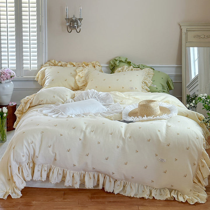 Vintage-inspired bedding set with ruffles and delicate floral embroidery