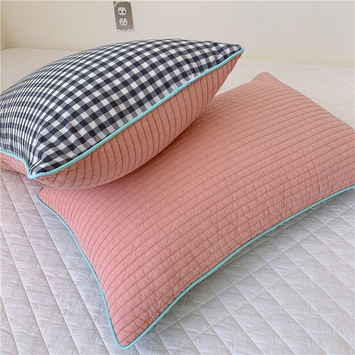 Reversible quilted pillow set with checked cotton cover and contrasting piping
