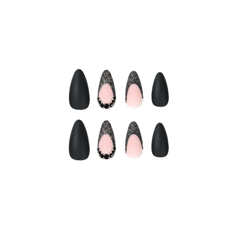 Artful stiletto nails with elegant black design and glitter accents Kalsten