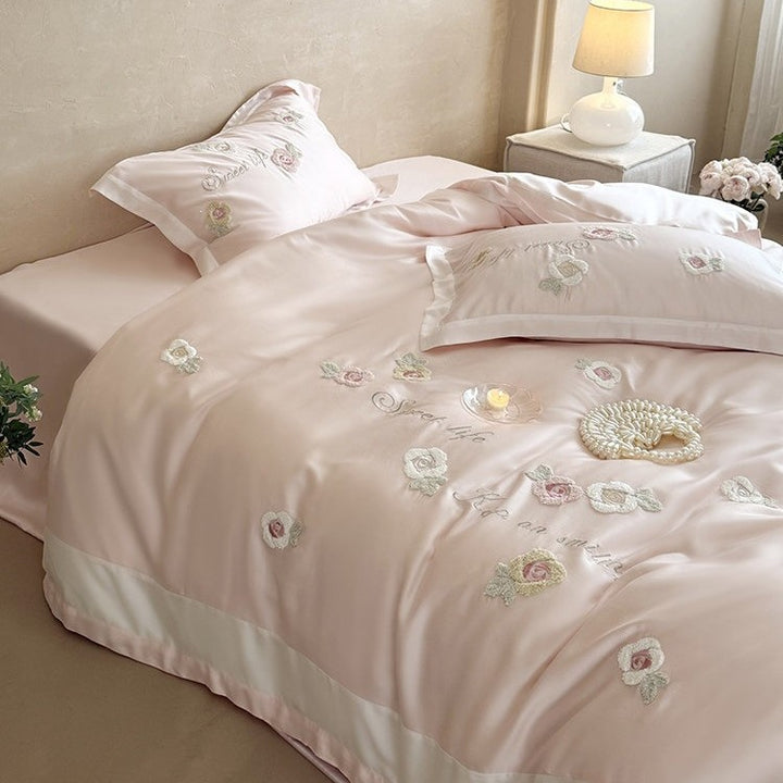 Luxurious satin bedding set with embroidered rose appliqués and silky glossy finish