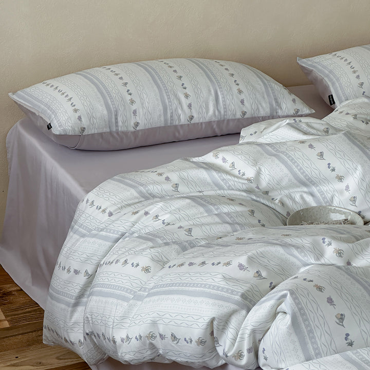 Cotton percale bed linen set with subtle floral stripe pattern and reversible material