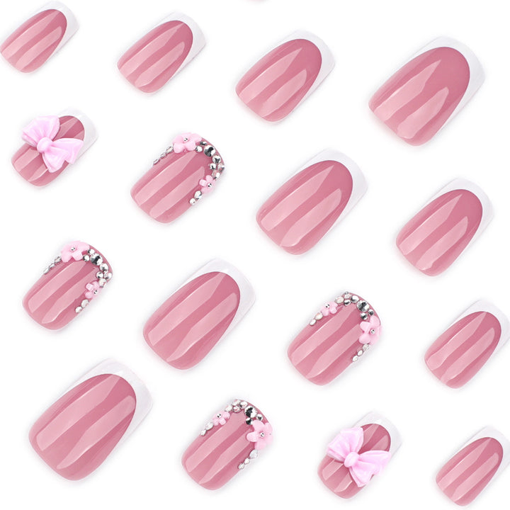 Artful nail extensions with sparkling accents and bow decorations Kalsten