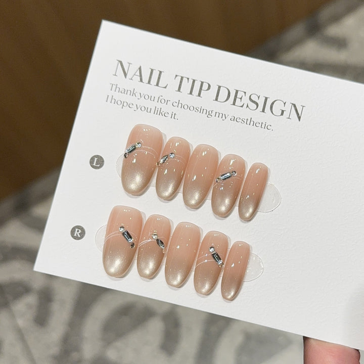 Artificial nail tips with elegant gradient color and rhinestone accents Kalsten
