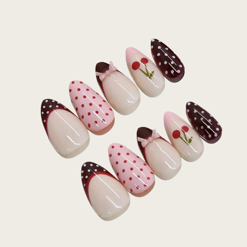 Artfully designed nail tips with cherry and dot motifs Kalsten