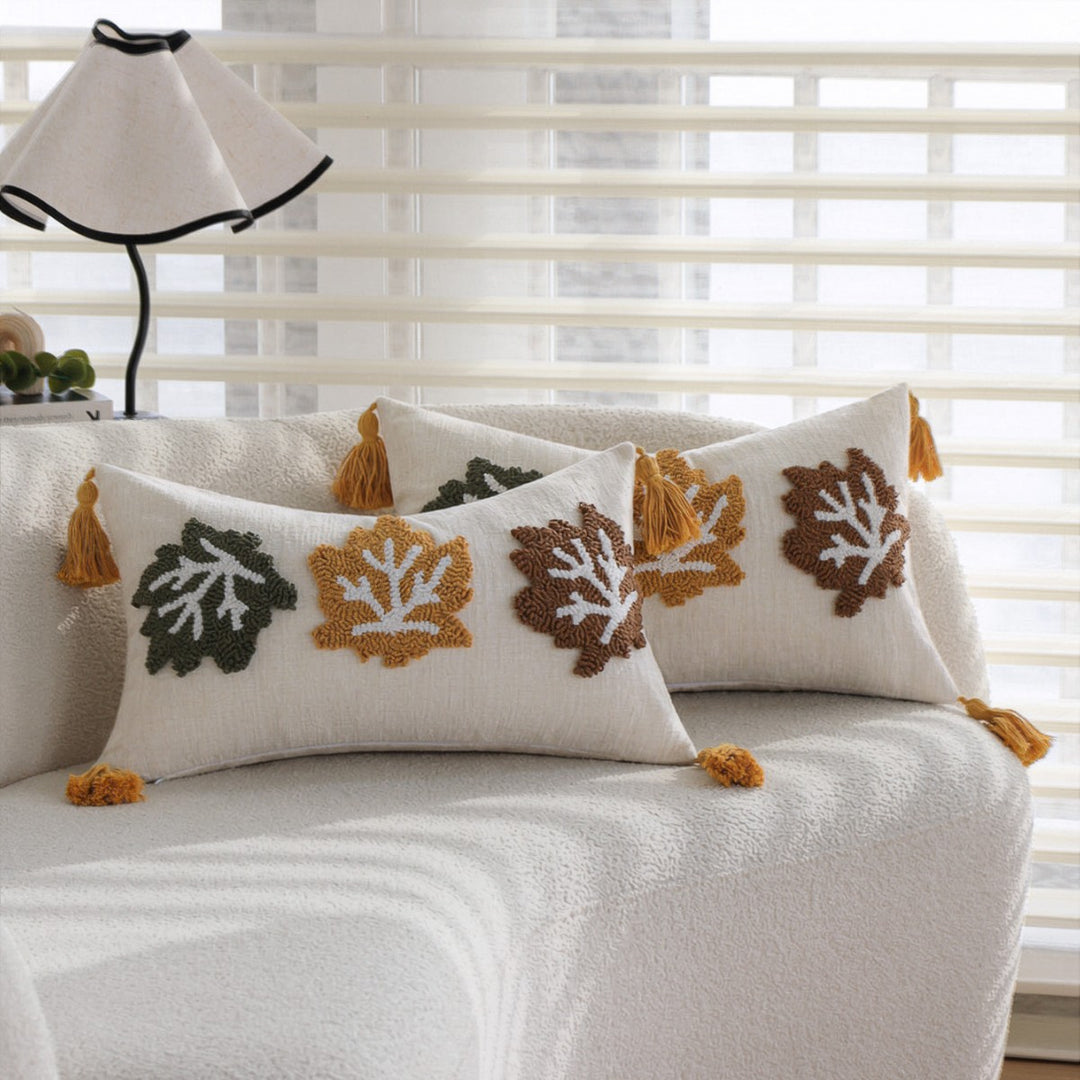 Rectangular decorative cushion cover made of linen look with raised leaf appliqués and corner tassels Kalsten