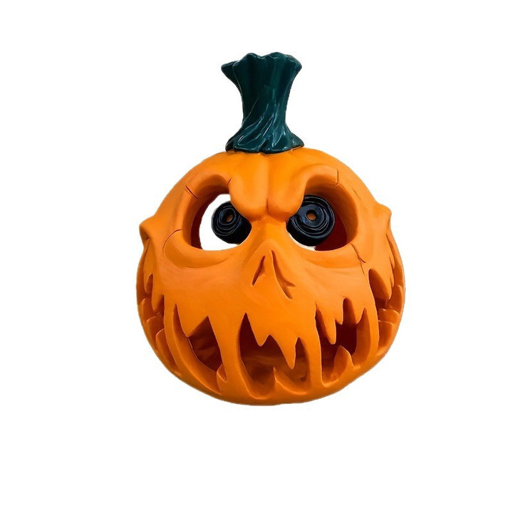 Ceramic pumpkin lantern with hollowed-out spooky face and tealight compartment