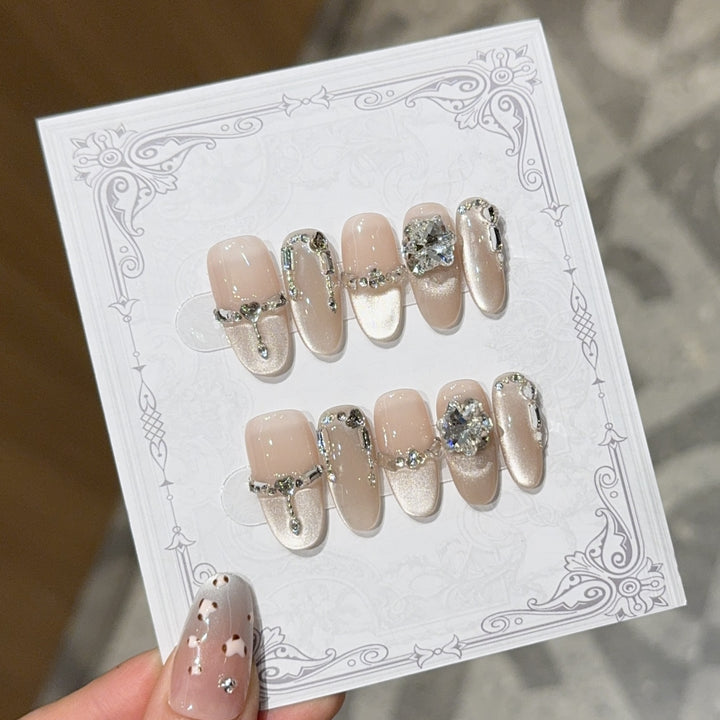 Glamorous nail tips with rhinestone and glitter effects Kalsten