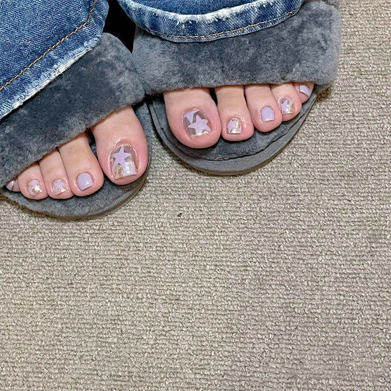 Artistic toenail art with rhinestone and glitter elements Kalsten