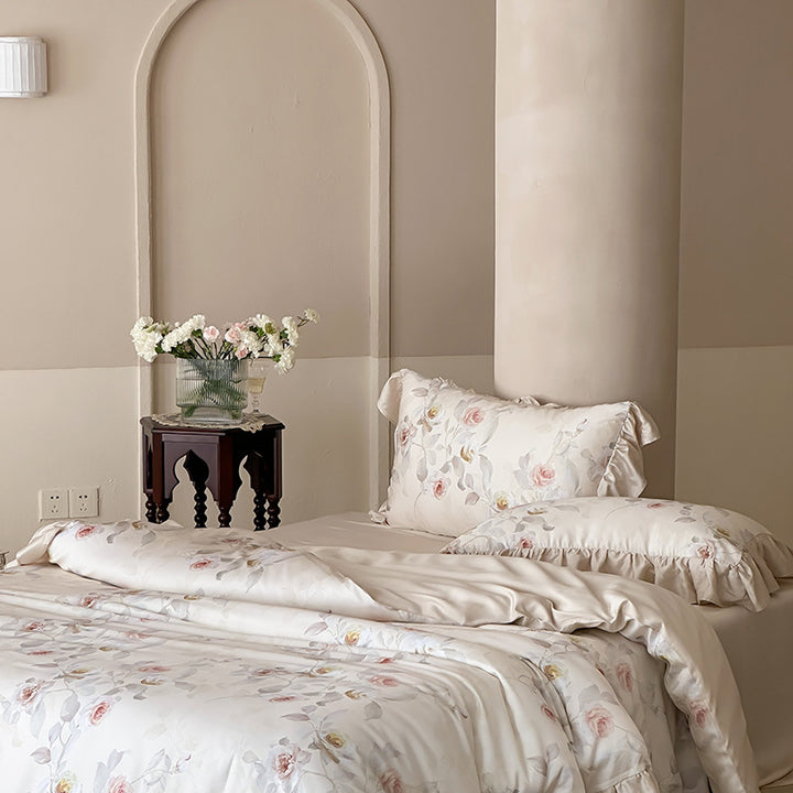 Luxurious satin bedding set with ruffled pillows and delicate watercolor rose print