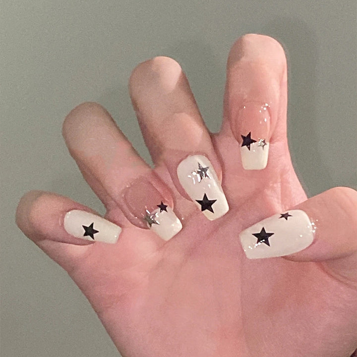 Artificial nail set with glamorous star design and sparkling accents Kalsten