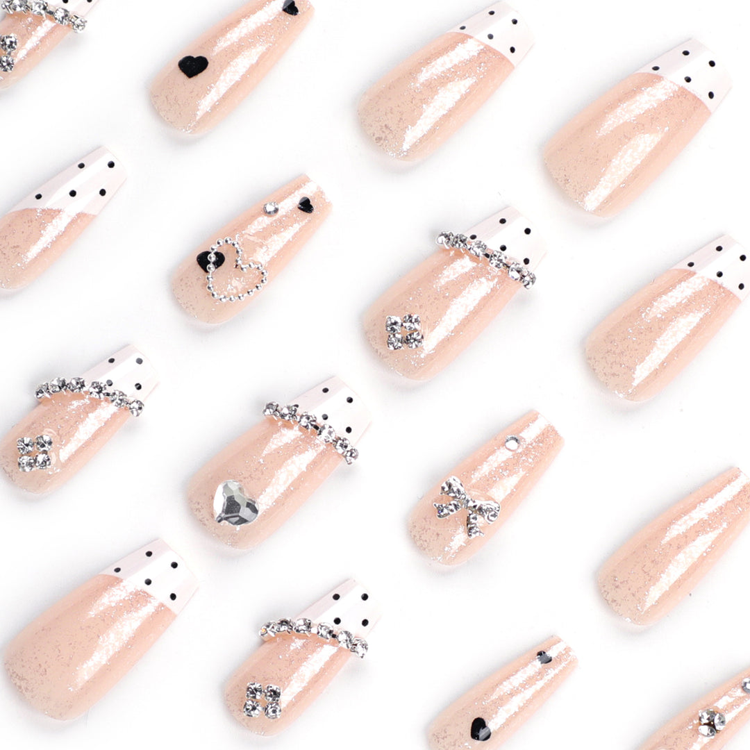Artful nail extensions with elegant rhinestone and heart designs Kalsten