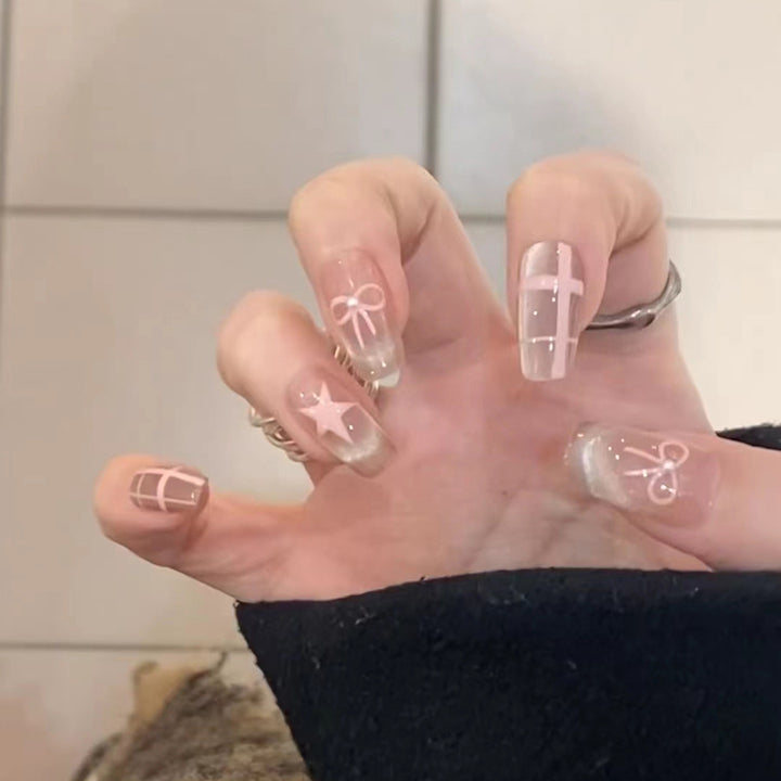Artistic acrylic nails with elegant bow and star designs Kalsten