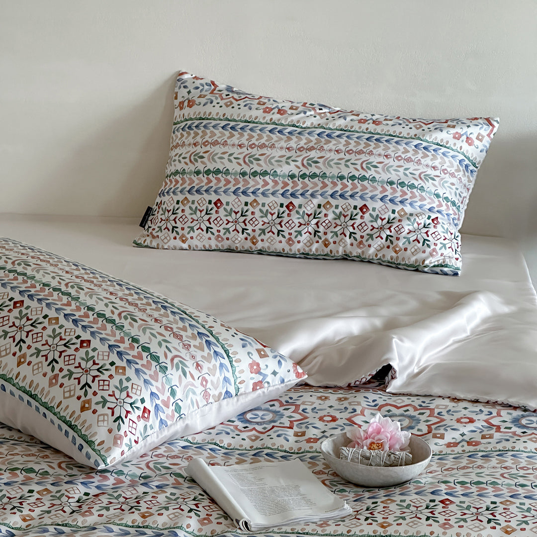 Satin bed linen set with ruffled bed skirt and floral printed pillowcases