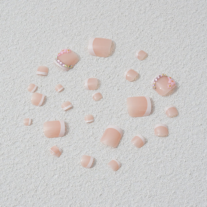 Elegant toenail art with delicate 3D floral decorations Kalsten