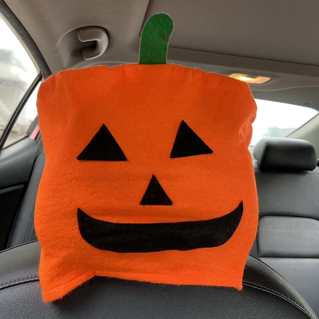 Plush decorative pillow with pumpkin face