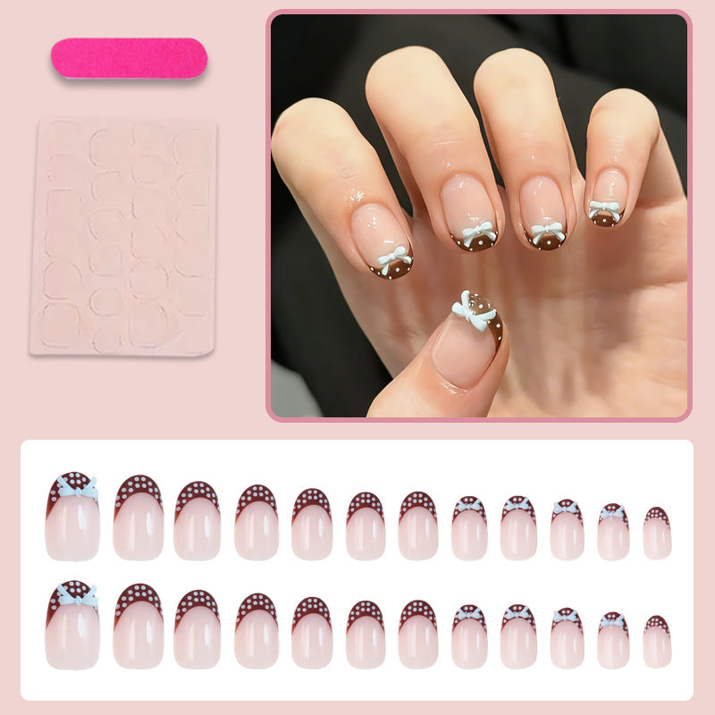 Artificial nail set with playful bows and elegant dots Kalsten