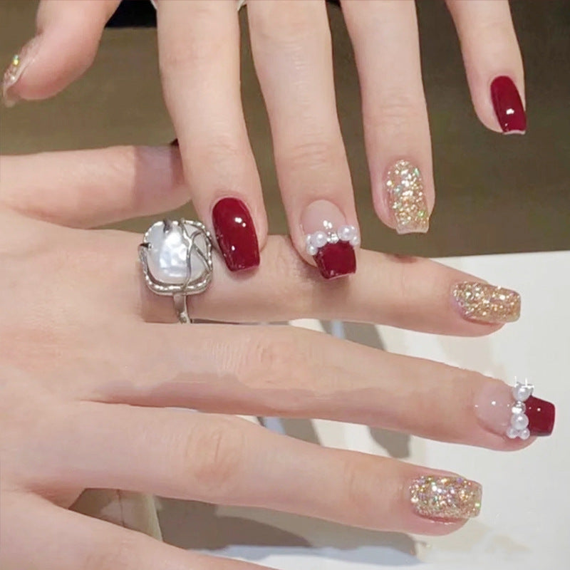 Glamorous artificial nails with glitter and pearl decorations Kalsten