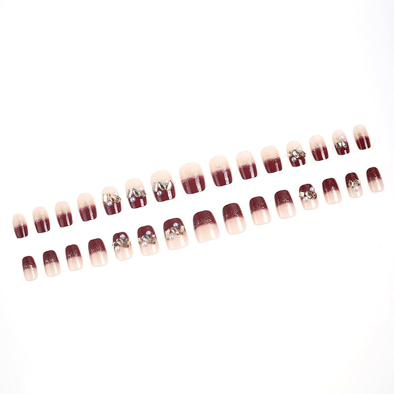 Glamorous artificial nails with decorative pearl and glitter embellishments Kalsten