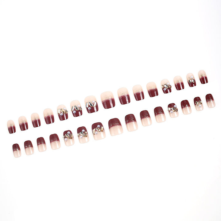 Glamorous artificial nails with decorative pearl and glitter embellishments Kalsten