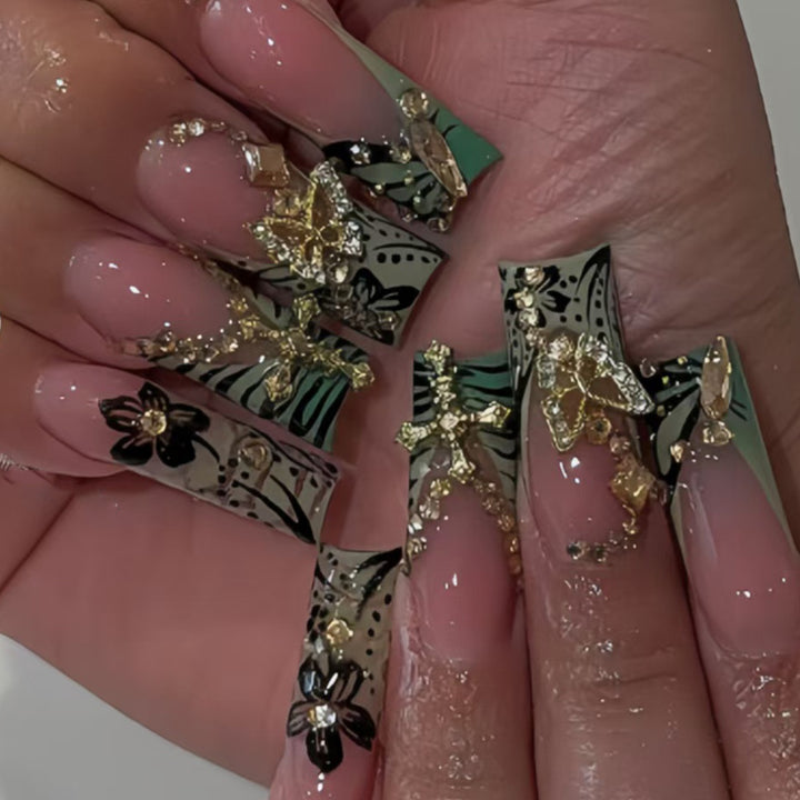 Artistic Stiletto Nail Design with Floral Accents and Gems Kalsten