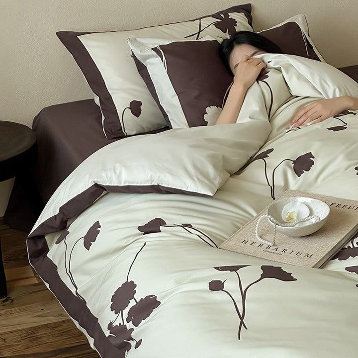 Reversible cotton satin bedding set with floral silhouette print and contrasting piped edge
