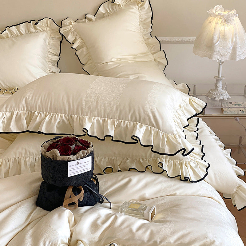 Noble cotton satin bedding set with flounce ruffles, jacquard floral border and contrasting piping.