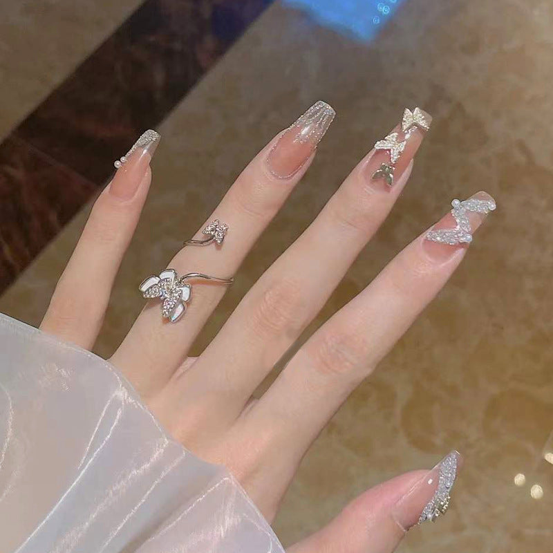 Artificial nails with sparkling rhinestone and bow accents Kalsten