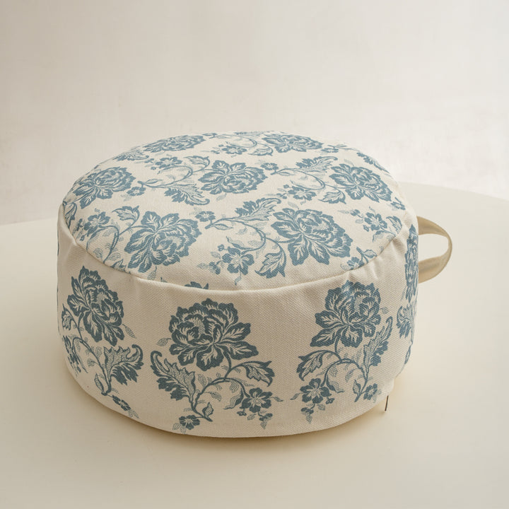 Round seat pouf with floral jacquard weave, stable upholstery core, and carrying handle Kalsten