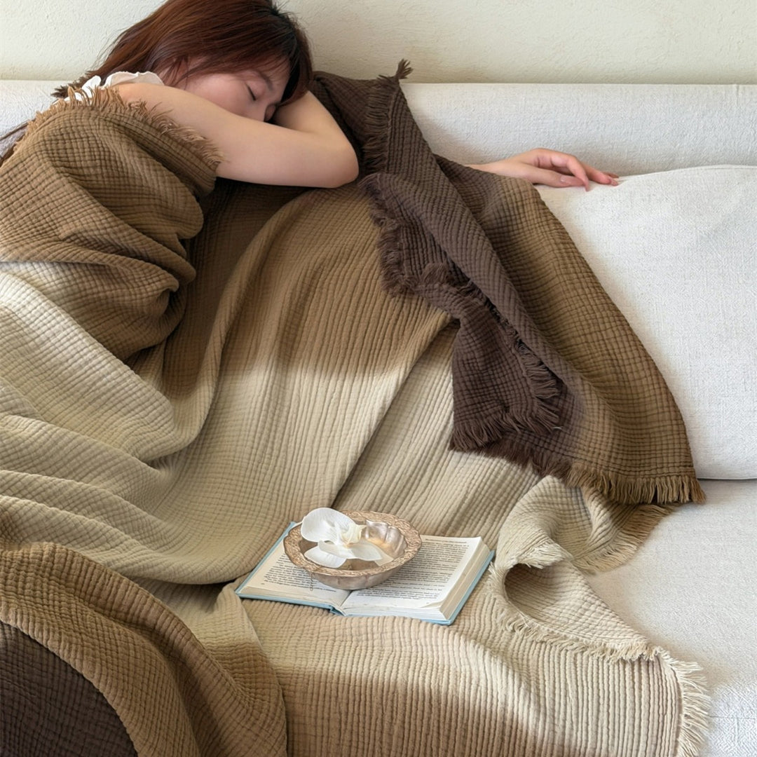 Large waffle blanket with ombre coloring and decorative fringes