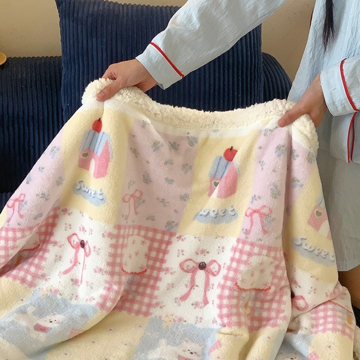 Reversible cuddle blanket with Sherpa fleece, cute dog illustrations and checkered pattern