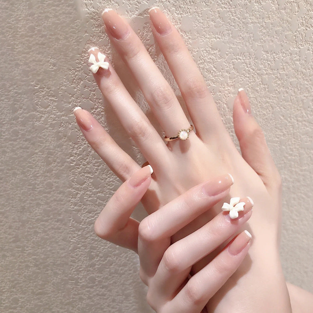 Glamorous artificial nails with heart design and glittering accents Kalsten