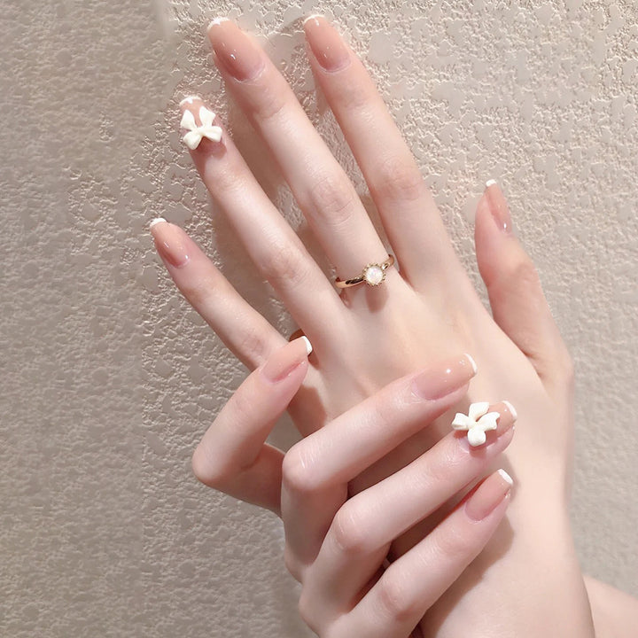 Glamorous artificial nails with heart design and glittering accents Kalsten