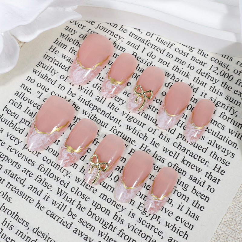 Acrylic nail set with elegant tips and delicate embellishments Kalsten