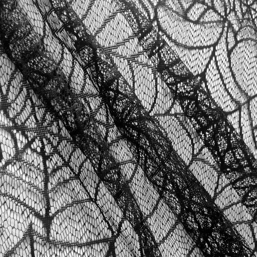 Transparent lace table cover with spider web design for Halloween decor