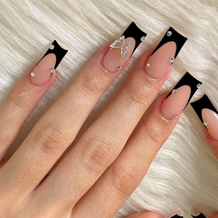 Acrylic nail set with elegant black and white design and glitter accents Kalsten