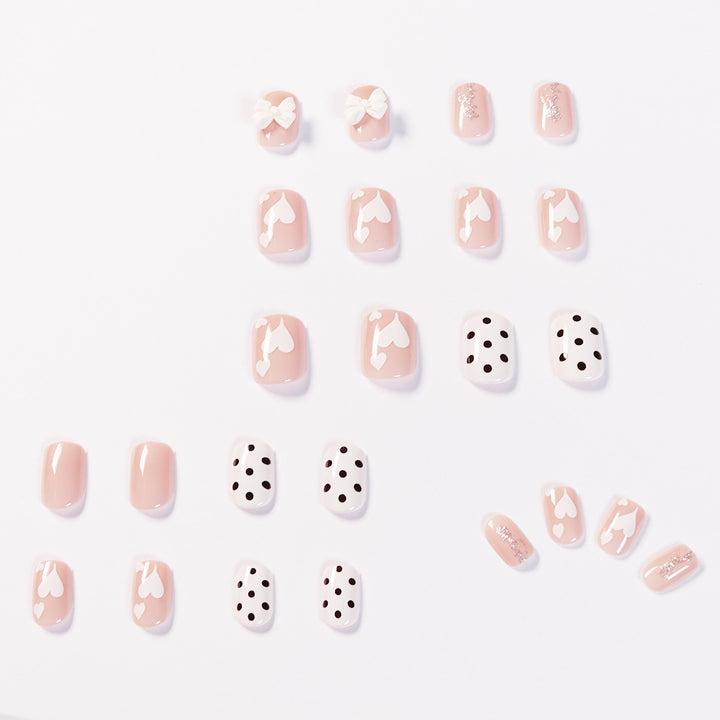 Artful nail art with delicate flower and heart motifs Kalsten