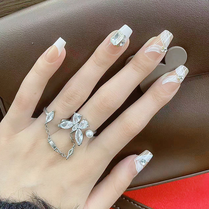 Elegant artificial nail set with delicate decorations and glitter elements Kalsten
